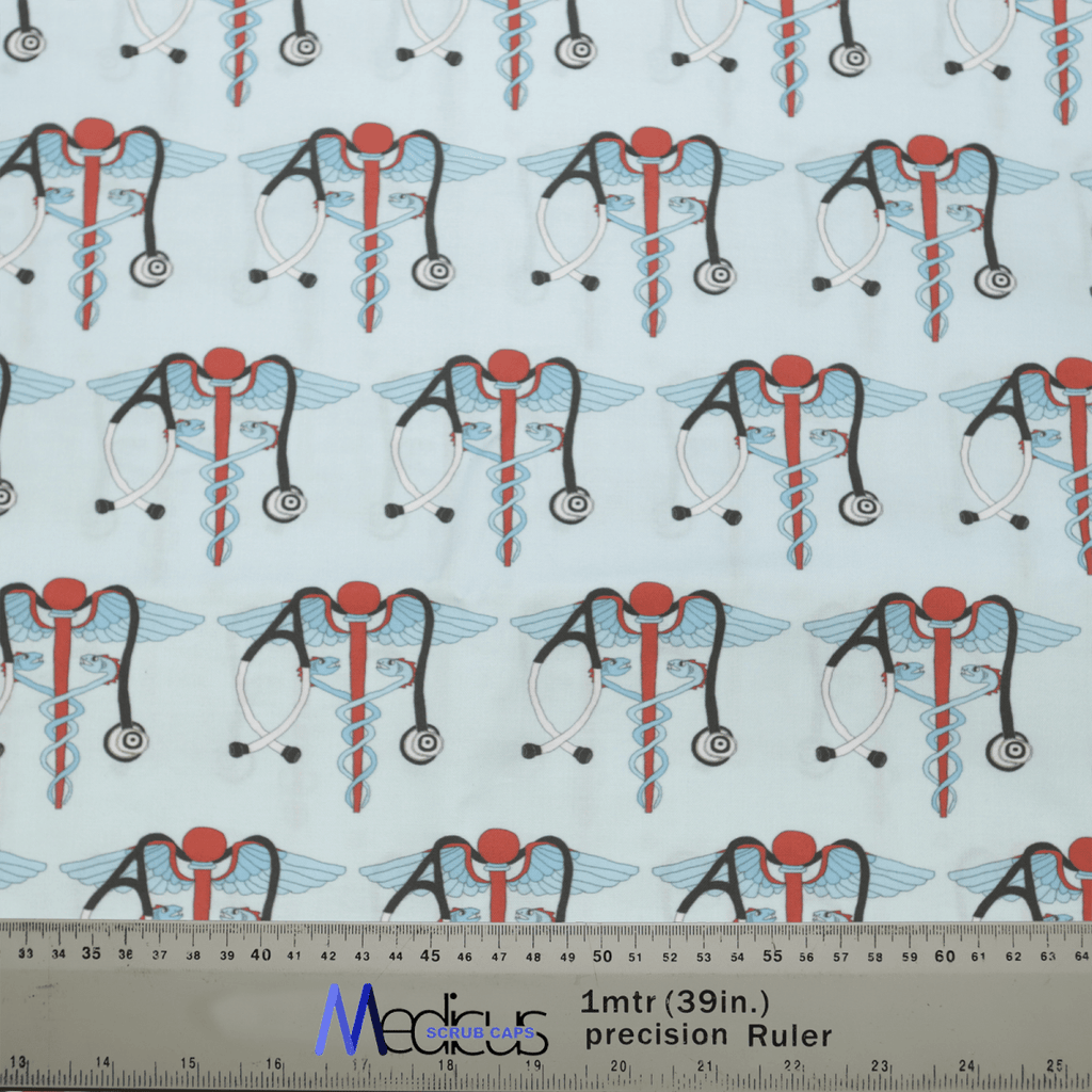 The patterned fabric includes medical snake caduceus symbols with wings, red circles, stethoscopes, and intertwined blue and red rods on a light background. Perfect for the Medicus Scrub Caps Medical Snake Caduceus Logo Blue USA Scrub Cap. Includes a one-meter ruler in centimeters and inches for scale.