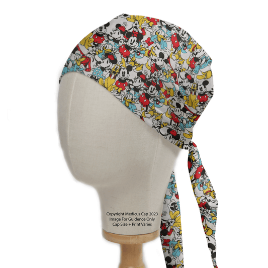 The mannequin head wears a vibrant Mickey + Friends Retro Gang Scrub Cap by Medicus Scrub Caps, featuring beloved Disney icons. Tied at the back for comfort, it pops with red, black, yellow, and blue cartoon designs.