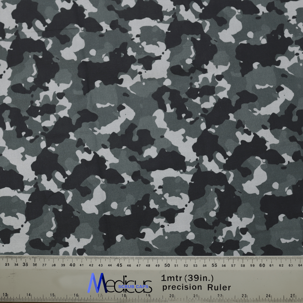 The Medicus Scrub Caps Military Camouflage Grey Scrub Cap features a black, grey, and white military pattern. A 1mtr (39in.) precision Ruler shows scale in inches and centimeters, perfect for crafting a stylish and comfortable cap for healthcare professionals.
