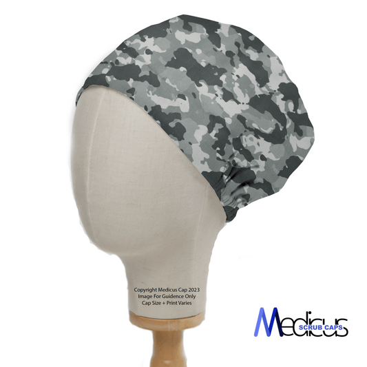 A mannequin head displays the Military Camouflage Light Grey Scrub Cap by Medicus Scrub Caps, featuring a stylish grey camouflage pattern for medical professionals.