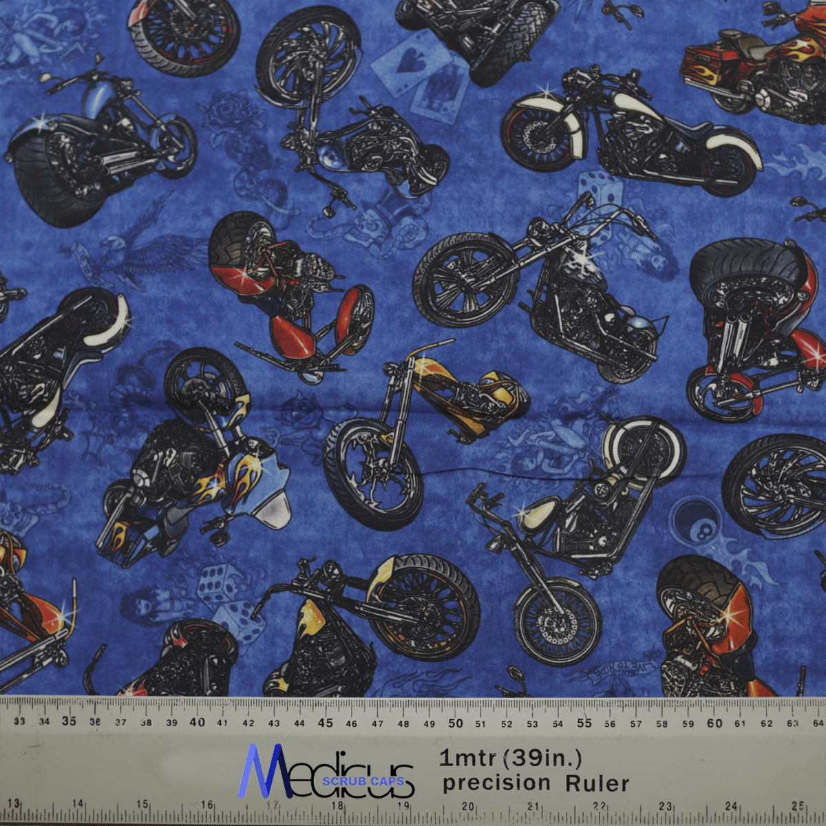 The Motorbikes Dark Blue Scrub Cap by Medicus Scrub Caps showcases diverse motorcycles in vibrant styles and colors on a dark blue fabric, with a gray precision ruler at the bottom adding to its dynamic design, blending style with comfort.