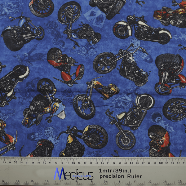 The Motorbikes Dark Blue Scrub Cap by Medicus Scrub Caps showcases diverse motorcycles in vibrant styles and colors on a dark blue fabric, with a gray precision ruler at the bottom adding to its dynamic design, blending style with comfort.