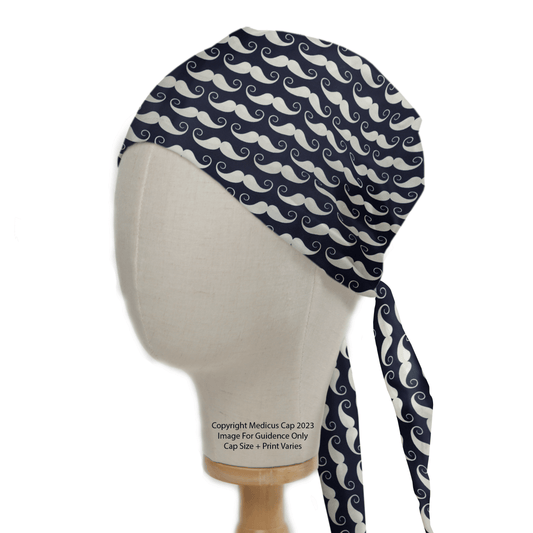 A mannequin head models the Medicus Scrub Caps Moustache Dark Blue Scrub Cap, adorned with white wave patterns. This stylish yet functional accessory features side ties that elegantly hang down.