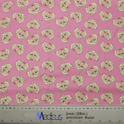 The Muppets Miss Piggy Toss Scrub Cap by Medicus Scrub Caps features a pink fabric with cartoon Miss Piggy sporting blonde hair and pearl earrings. Its perfect for healthcare professionals seeking style in the medical field, complete with a ruler for easy measurement.