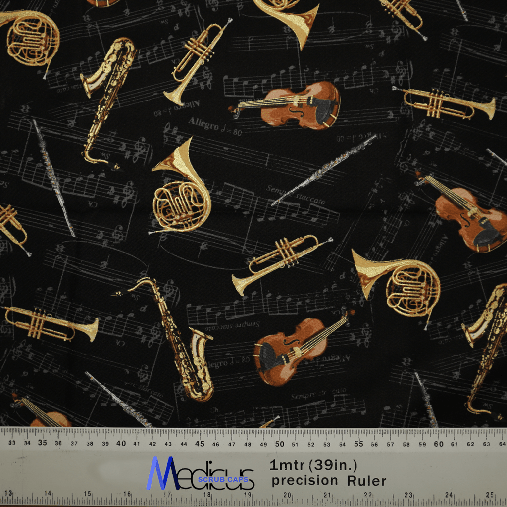 The Musical Instruments Scrub Cap by Medicus Scrub Caps features an eco-friendly fabric with violins, French horns, and saxophones on a black background with musical notes. A one-meter ruler is shown at the bottom for scale.