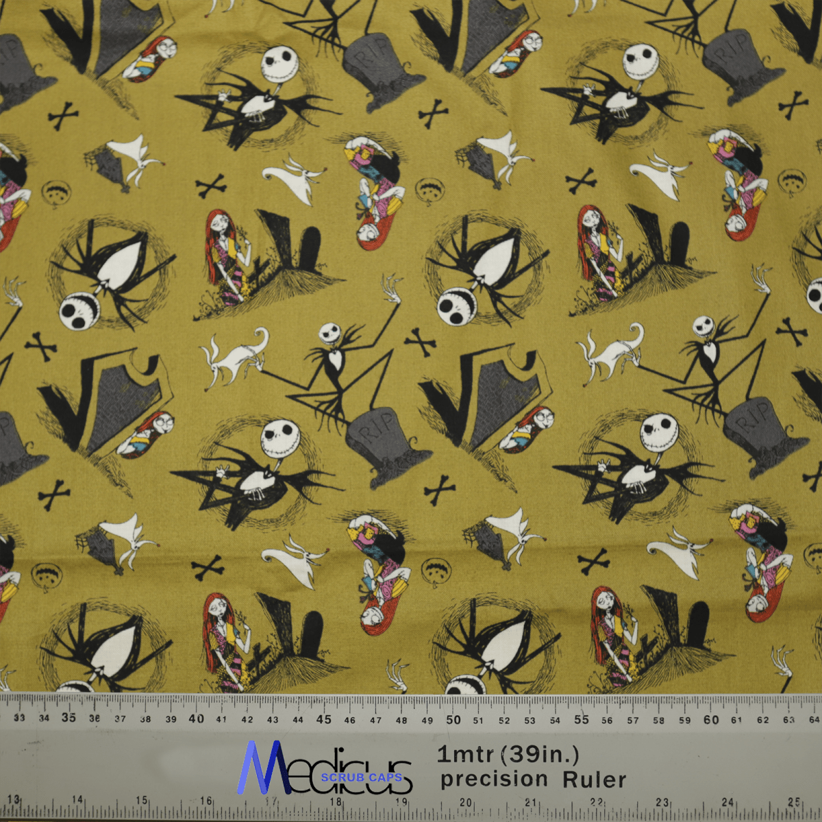 The Nightmare Before Christmas #2 Scrub Cap from Medicus Scrub Caps features a whimsical design with cartoon skeletons, ghosts, and other Halloween characters on a yellow background. A ruler at the bottom shows measurements in inches and meters.