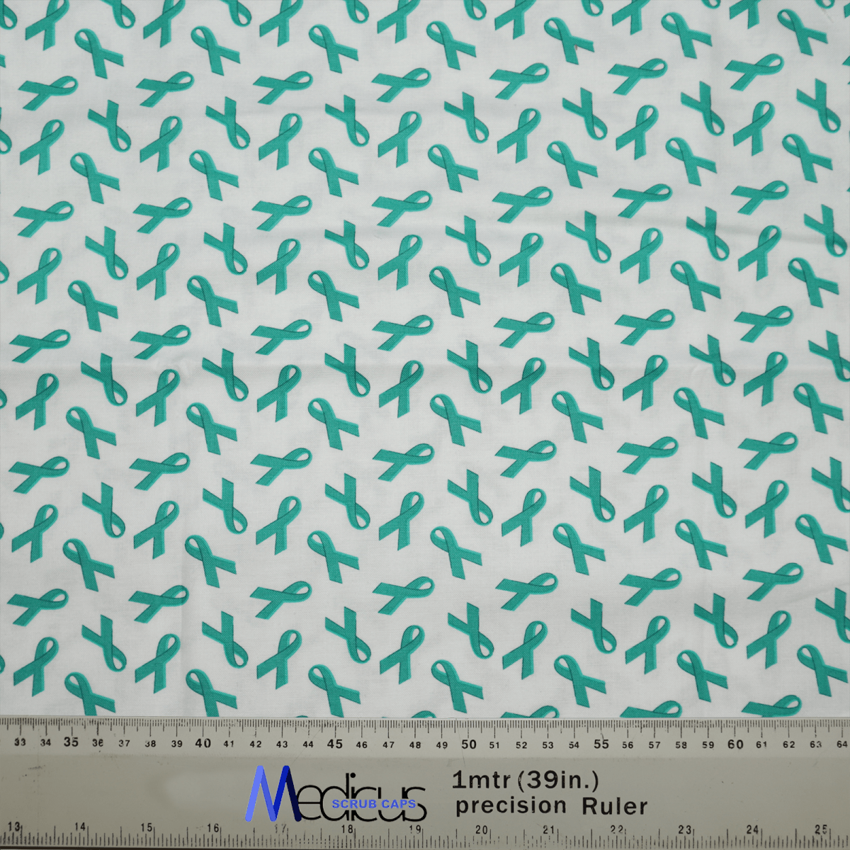 The Ovarian Cancer Awareness Scrub Cap by Medicus Scrub Caps features teal ribbons on white fabric, complete with a ruler for size reference. This eco-friendly design offers personalization to suit your unique needs.