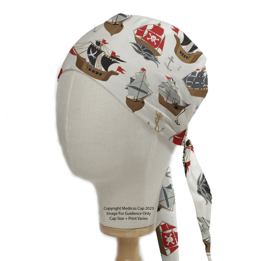 A mannequin head models the Medicus Scrub Caps Pirate Ships Scrub Cap, showcasing a white design with playful pirate ships, red and black sails, skulls, and anchors. It promises comfortable all-day wear with an eco-conscious style for adventure-loving individuals.