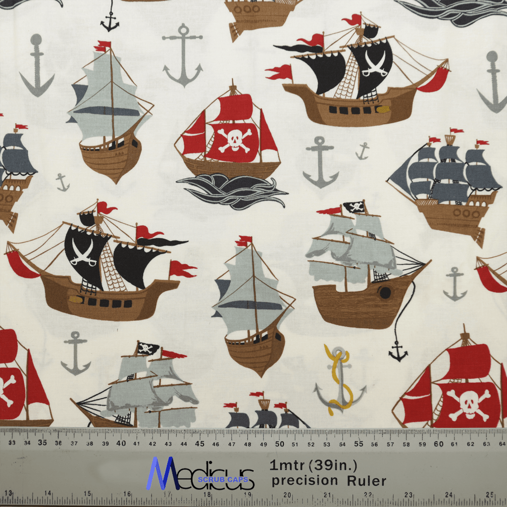 The Pirate Ships Scrub Cap by Medicus Scrub Caps features a pattern with pirate ships and red, gray, and beige sails. Some ships have skull and crossbones flags, with gray anchors scattered in the background. Perfect for an eco-conscious choice for comfortable all-day wear. A ruler is shown for scale.
