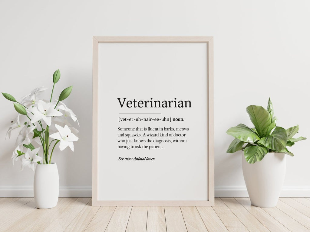 A Poster - Veterinarian Definition, depicting vets as fluent animal speakers with magical diagnostic skills, leans between two white vases. Customize the digital download to suit your space or pair it with Medicus Scrub Caps for a themed gift.
