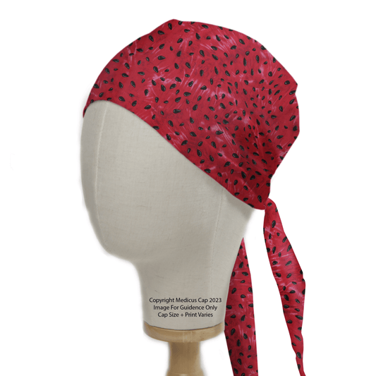 A mannequin head showcases an eco-friendly choice: the Print Watermelon Seeds Scrub Cap by Medicus Scrub Caps. It features a watermelon seed pattern in red, with tied straps at the back for a comfortable fit.