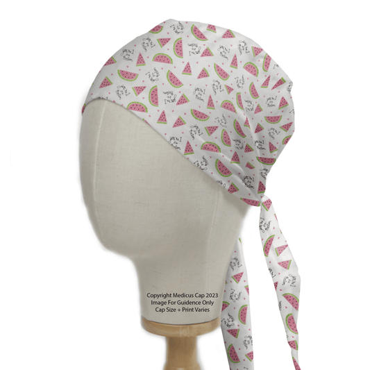 The mannequin head displays Medicus Scrub Caps eco-friendly Pun-tastic: 1 in a Melon scrub cap, adorned with pink watermelon slices and gray cat illustrations. Ideal for healthcare workers, it features long back ties, adding a playful touch to professional attire.