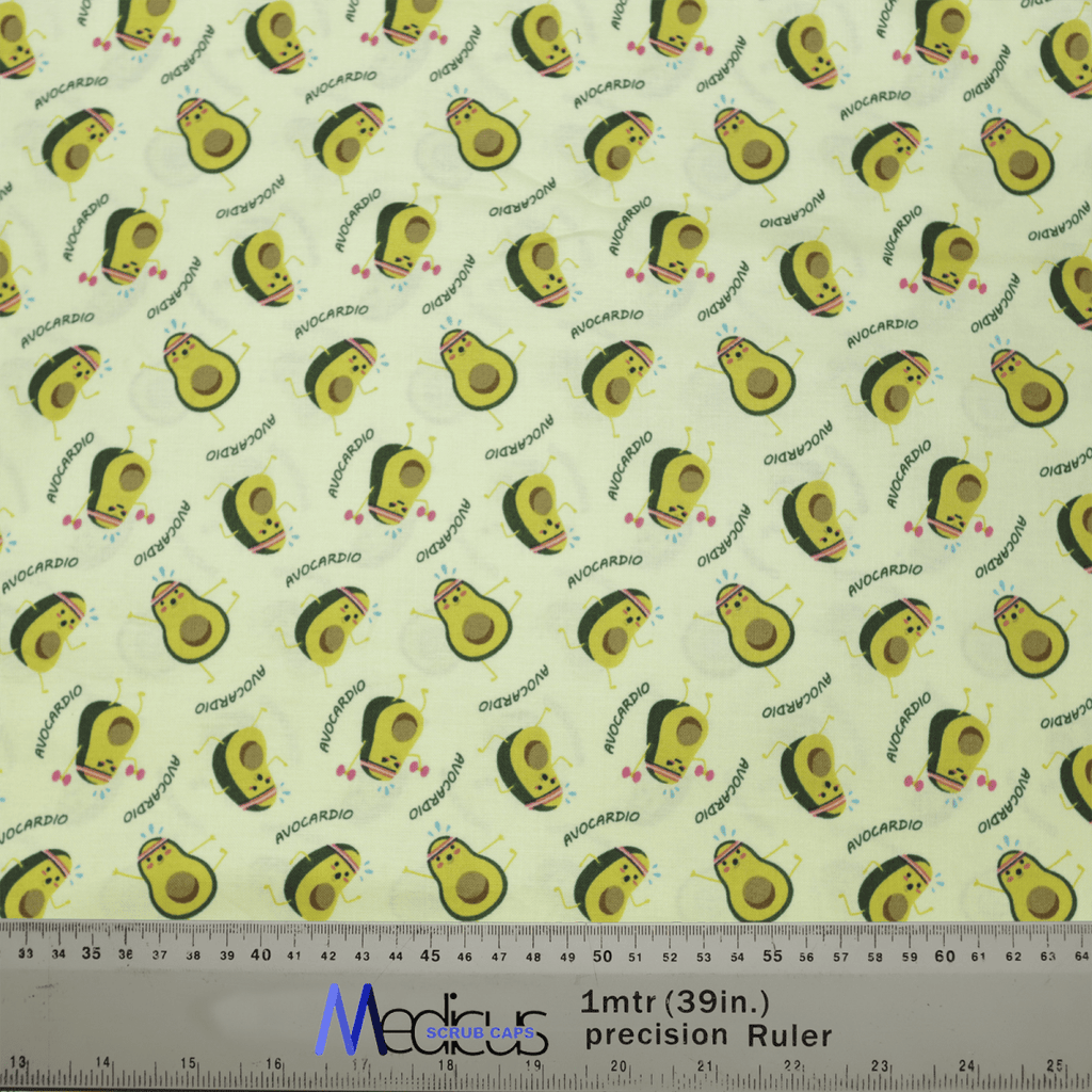 The Pun-tastic: Avo-cardio Scrub Cap by Medicus Scrub Caps features smiling avocados and AVOCARDIO on a light yellow background. Perfect for healthcare professionals, its eco-friendly with a ruler shown for scale.