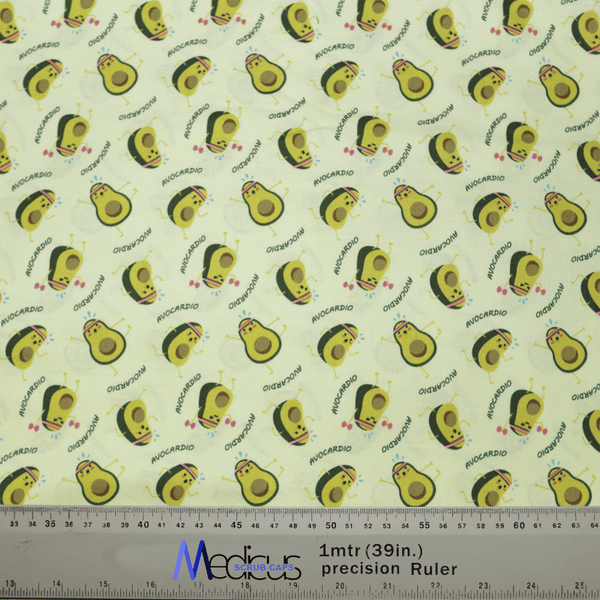 The Pun-tastic: Avo-cardio Scrub Cap by Medicus Scrub Caps features smiling avocados and AVOCARDIO on a light yellow background. Perfect for healthcare professionals, its eco-friendly with a ruler shown for scale.
