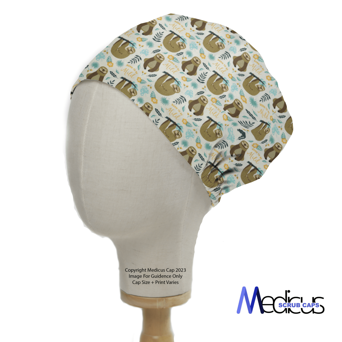 A mannequin head models the Pun-tastic: Born To Be Mild Scrub Cap by Medicus Scrub Caps, featuring sloths, leaves, and flowers on a light background with green, yellow, and blue accents. The logo is displayed on the bottom right of this eco-friendly choice for medical professionals.