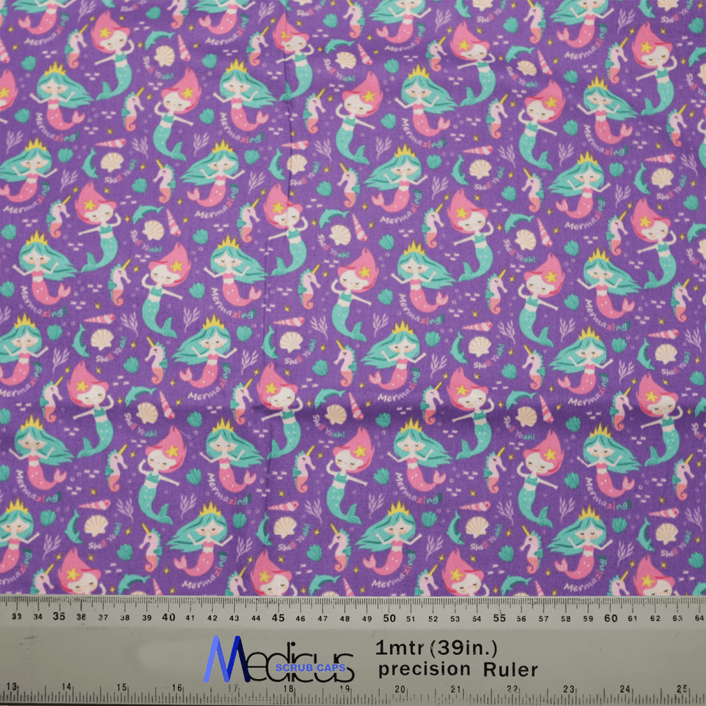 Introducing the eco-friendly Pun-tastic: Mermazing! Scrub Cap by Medicus Scrub Caps, featuring a purple fabric with vibrant mermaid illustrations, coral, shells, and seaweed. A handy ruler at the bottom offers measurement markings for added convenience and comfort.