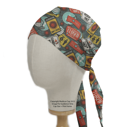 The mannequin head models the Medicus Scrub Caps Quarantine / Lockdown Central scrub cap, featuring pandemic-themed illustrations such as Closed and Quarantine. Perfect for healthcare workers, it includes images of masks and biological hazards, all on eco-friendly material.