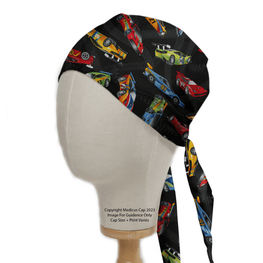 A Medicus Scrub Caps mannequin showcases the Racing Cars Motorsport Scrub Cap featuring colorful racing cars on a black background. The cap ties at the back, with cars arranged dynamically to capture a vibrant motorsport theme.