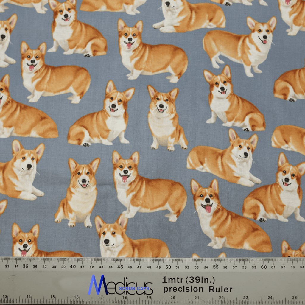 The Royal Corgi Dogs Scrub Cap by Medicus Scrub Caps features charming Corgis on a gray background in various poses, with a ruler for precise measurements. An eco-friendly option perfect for healthcare professionals!.