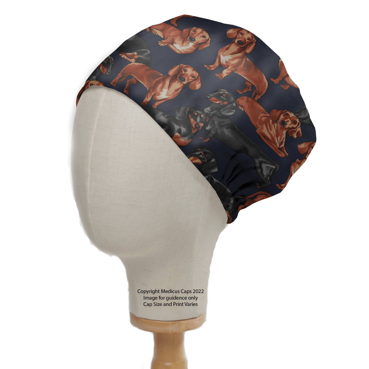 The Medicus Scrub Caps Sausage Dachshund Dog Scrub Cap features a navy background with prints of brown and black sausage dachshunds in various poses—ideal for healthcare professionals.