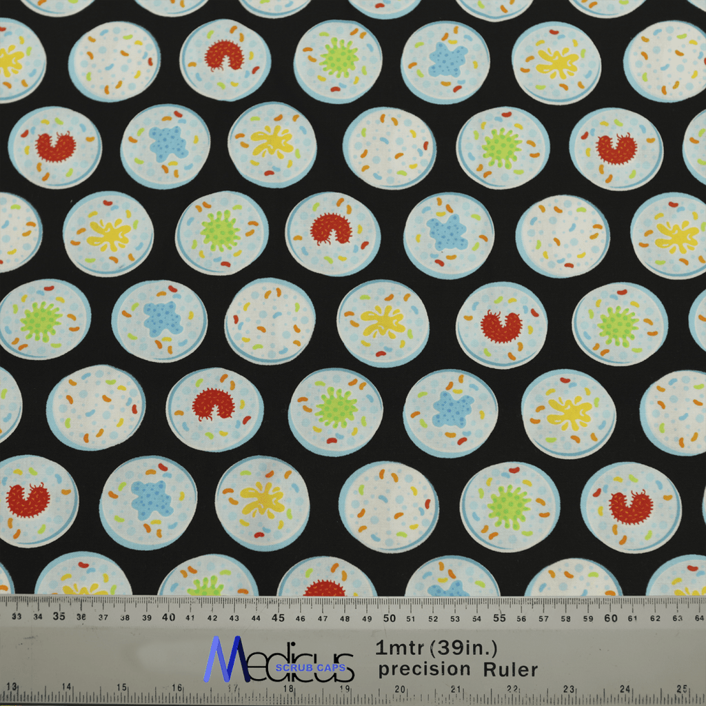 The Science Epidemic Petri Dishes Scrub Cap by Medicus Scrub Caps features rows of blue circles with colorful abstract designs inside, resembling cells on a black background. A ruler at the bottom displays measurements in inches and meters.