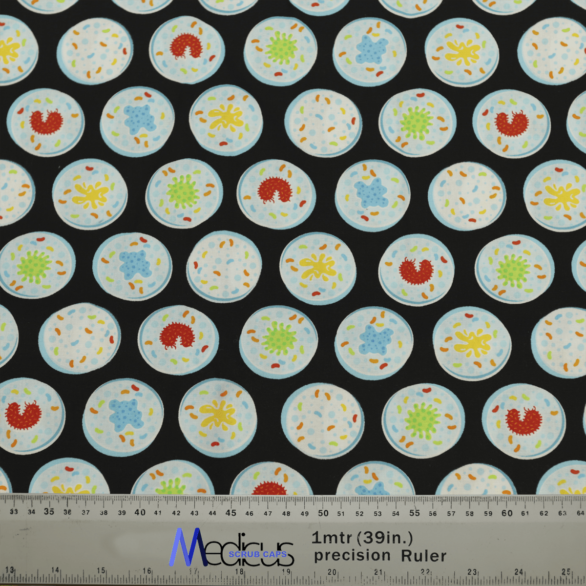 The Science Epidemic Petri Dishes Scrub Cap by Medicus Scrub Caps features rows of blue circles with colorful abstract designs inside, resembling cells on a black background. A ruler at the bottom displays measurements in inches and meters.