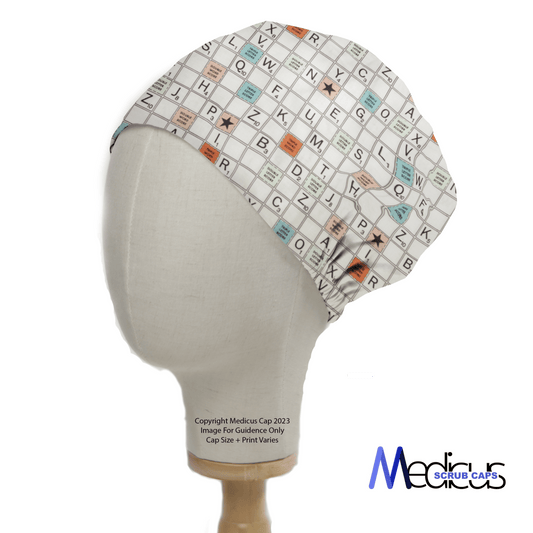 A mannequin displays the Medicus Scrub Caps Scrabble Board Scrub Cap, merging playful professionalism with a crossword design of letters and numbers. It features orange and blue squares for a comfortable fit, branded in the bottom right corner.