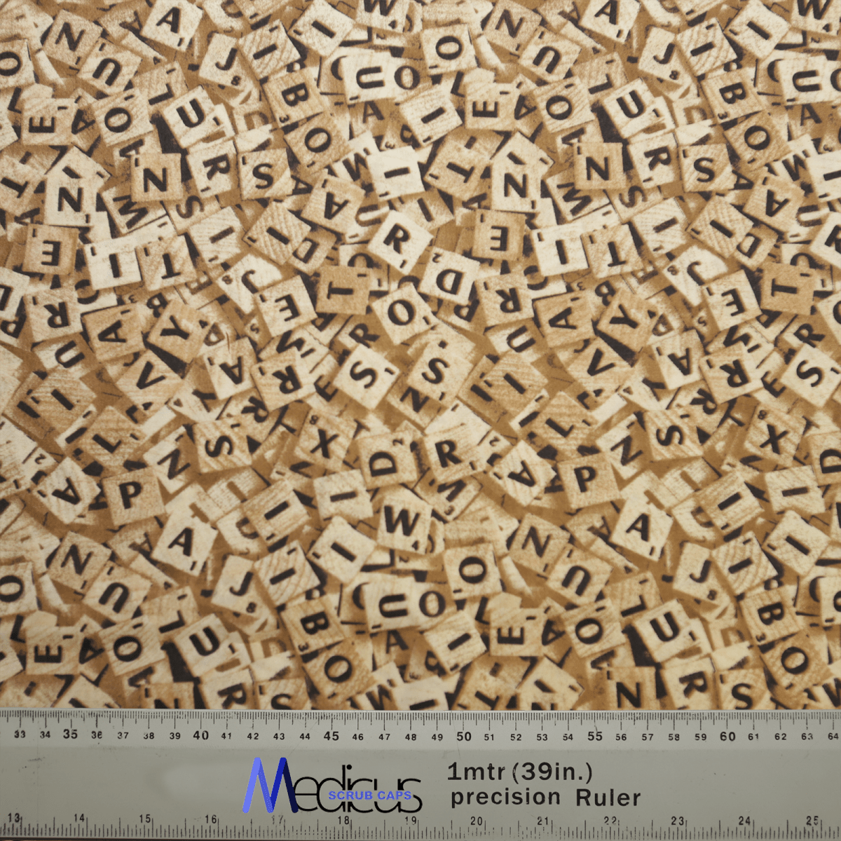 A chaotic pile of wooden Scrabble tiles, covering the surface like an intricate Medicus Scrub Caps Scrabble Letters Scrub Cap. A ruler at the bottom shows measurements in inches and centimeters labeled 1 mtr (39 in.) precision Ruler in blue.