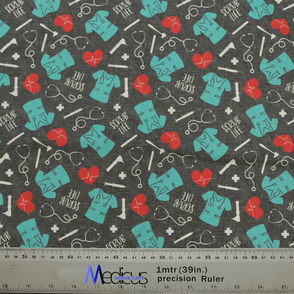The Scrub Life Scrub Cap by Medicus Scrub Caps features a teal scrub pattern with red hearts, lifelines, stethoscopes, and SCRUB LIFE text on a dark background—a tribute to healthcare professionals. A ruler for scale is included at the bottom.