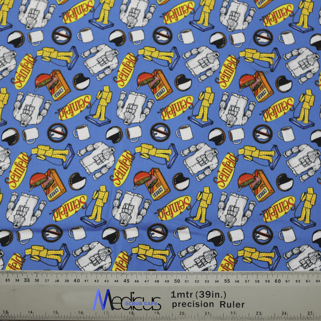 The Medicus Scrub Caps Seinfeld Breakfast Blue Scrub Cap is made from sustainable blue fabric featuring astronaut and rocket illustrations with explore in vivid yellow and red. A grey ruler marked with 39 in and 1 m is shown for scale. Ideal for healthcare professionals.