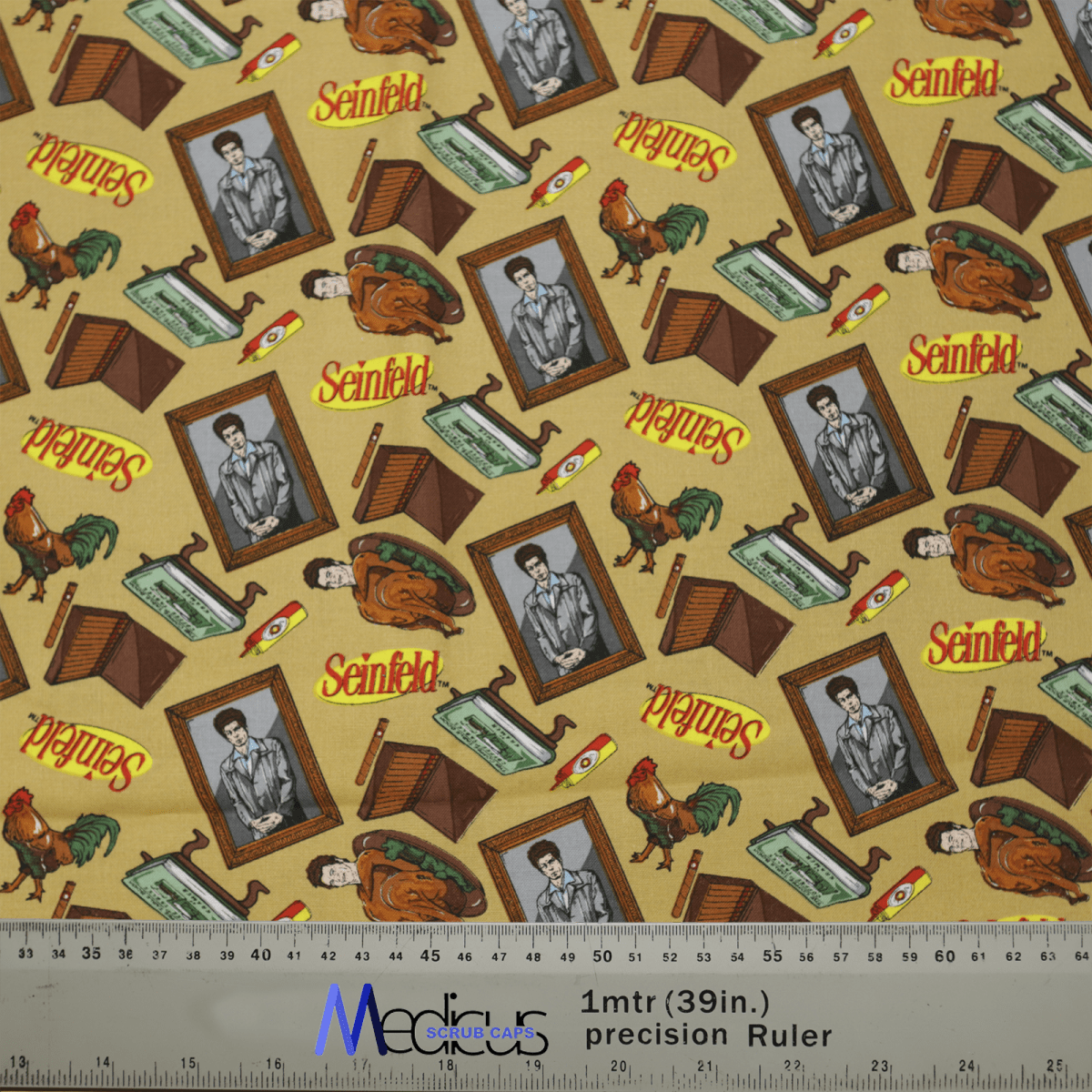 The Medicus Scrub Caps Seinfeld Wallpaper Scrub Cap showcases a pattern of a suited man, retro TVs, typewriters, bananas, and chickens. It ensures comfort with a gray ruler at the bottom displaying metric and imperial units against a beige background for an environmentally responsible design.