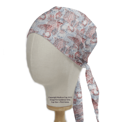 The mannequin head displays a Medicus Scrub Caps Skeleton 3D Vision Scrub Cap, adorned with light-colored designs and red anatomical illustrations. It features long ties at the back, combining style and practicality for enthusiasts.