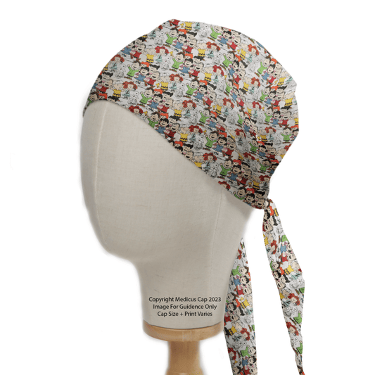 A mannequin head models a Snoopy Charlie Brown + Friends Scrub Cap by Medicus Scrub Caps, featuring a vibrant pattern of Snoopy and Charlie Brown on an eco-friendly white background with back ties.