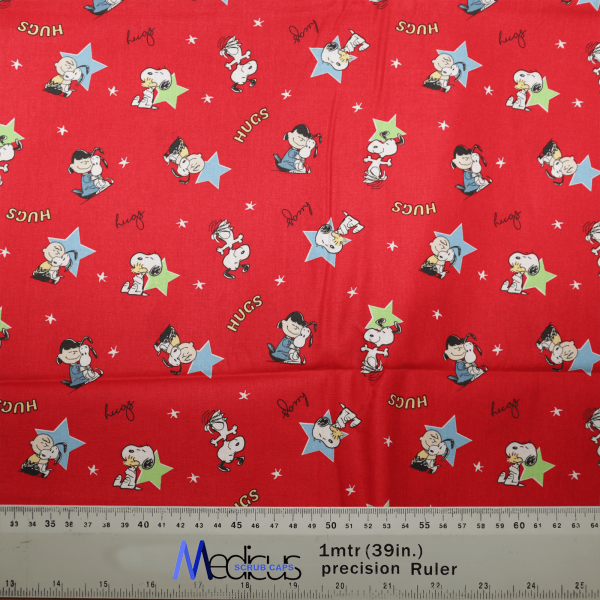 The Snoopy Charlie Hug Red Scrub Cap by Medicus Scrub Caps is a charming red cap with Snoopy and Charlie in fun scenes, adorned with blue and yellow stars and the word HUGS. It features a ruler showing inches for added detail. Sustainable, reusable, and ideal for daily wear.