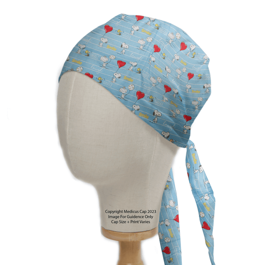 The Snoopy Heart Balloon Laugh Love Scrub Cap by Medicus Scrub Caps is an eco-friendly blue cap adorned with cartoon characters, hearts, and Smile. With a playful Snoopy heart balloon design against a white background, its ideal for adding whimsy to your professional attire.