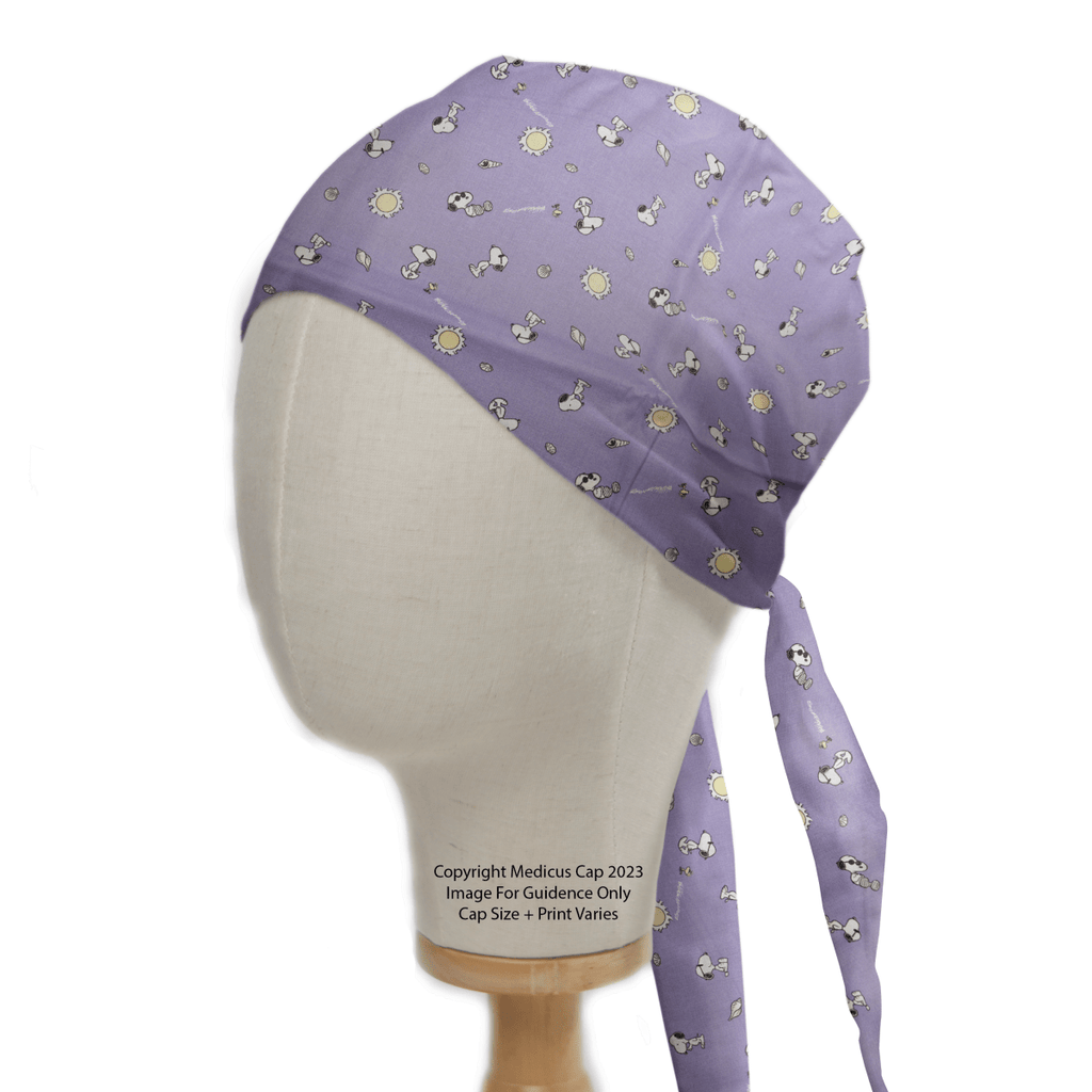A mannequin displays the Snoopy Purple Sunshine Friends Scrub Cap by Medicus Scrub Caps, featuring cartoon dogs and yellow suns with fabric ties at the back. Text states, Copyright Medicos Cap 2023. Image for guidance only. Cap size and print vary.