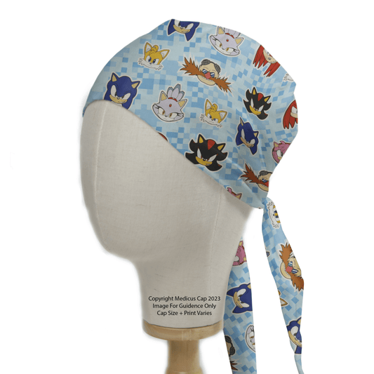 The Medicus Sonic Character Heads Scrub Cap features a blue pattern with cartoon faces. It ties securely at the back, ideal for medical professionals.