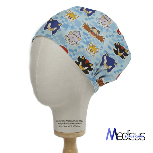 The Sonic Character Heads scrub cap by Medicus Scrub Caps features colorful cartoon faces on a checkered background, displayed on a mannequin head.