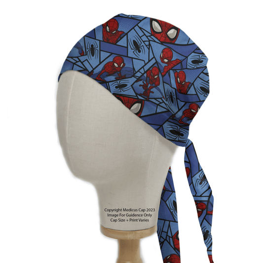 A Spiderman Comic Web Grid Scrub Cap by Medicus Scrub Caps, featuring a blue design with cartoon superheroes and black spider webs, is elegantly displayed on a mannequin head.