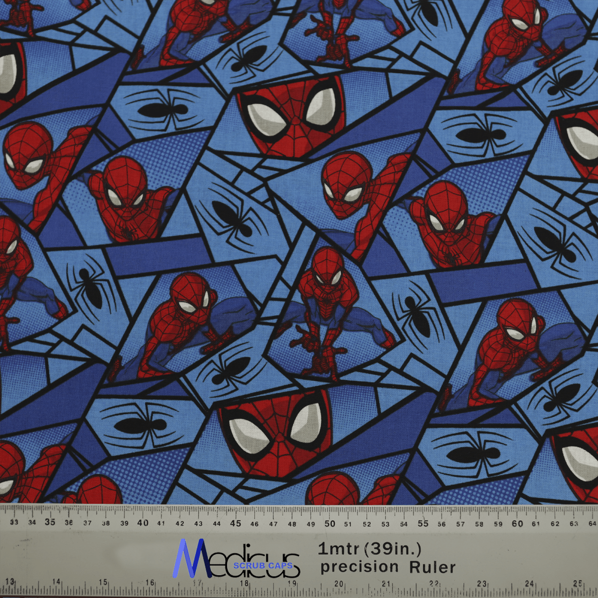 The Spiderman Comic Web Grid Scrub Cap by Medicus Scrub Caps features blue fabric with Spider-Man in various poses, spider web designs, and black spiders, ideal for a reusable scrub cap. A ruler at the bottom indicates scale at 1 meter or 39 inches.