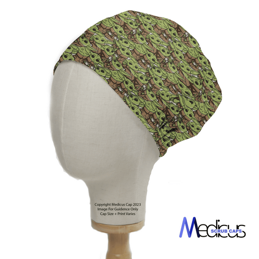 A mannequin head displays the Star Wars Baby Yoda Crowd Scrub Cap by Medicus Scrub Caps, featuring a colorful, abstract green and brown pattern. The cap has a gathered back for a secure fit and radiates intergalactic charm, with the brands logo visible at the bottom right.