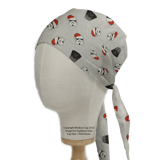 Medicus Scrub Caps presents the Star Wars Christmas Darth Vader Scrub Cap. This gray cap features stormtrooper helmets and stars, some adorned with red Santa hats, complete with back ties, making it a festive choice for the holiday season.