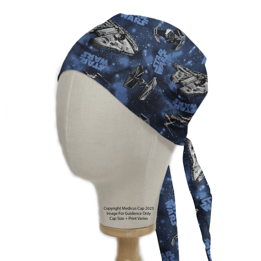 A mannequin head displays the Medicus Scrub Caps Star Wars Millennium Falcon On Blue Scrub Cap, showcasing the iconic ship on a starry blue background with Star Wars text.