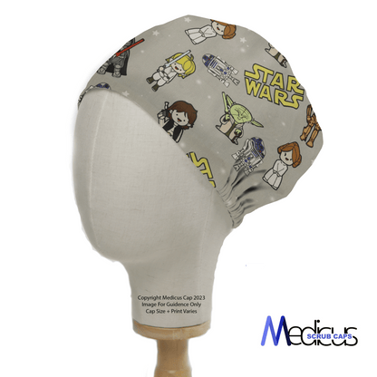 A mannequin head wears the Star Wars Original Kawaii Scrub Cap by Medicus Scrub Caps, showcasing cute cartoon characters and robots. This reusable cap is ideal for fans wanting style and functionality, with the brands logo at the bottom right.