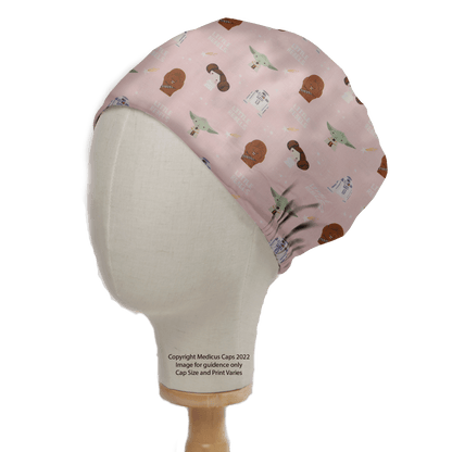 A mannequin head features the Medicus Scrub Caps Star Wars Pink Kawaii scrub cap, decorated with small green aliens, helmets, and droids. Its sustainably displayed on a wooden stand with text below.