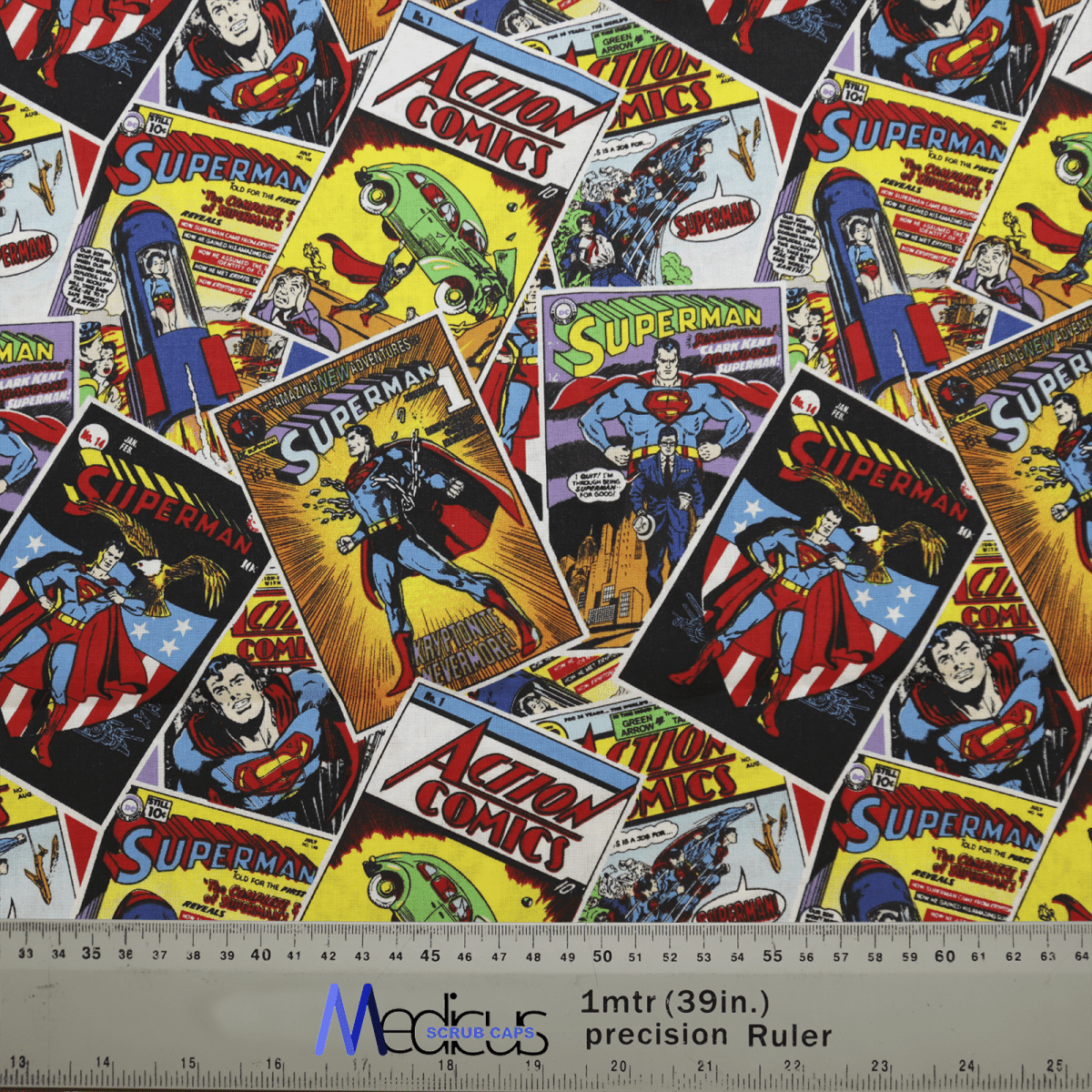 The Medicus Scrub Caps Superman Comic Book Covers Scrub Cap features vintage action scenes and iconic imagery on a ruler background marked 1m (39in) precision, ideal for reusable displays or superhero-themed inspiration.