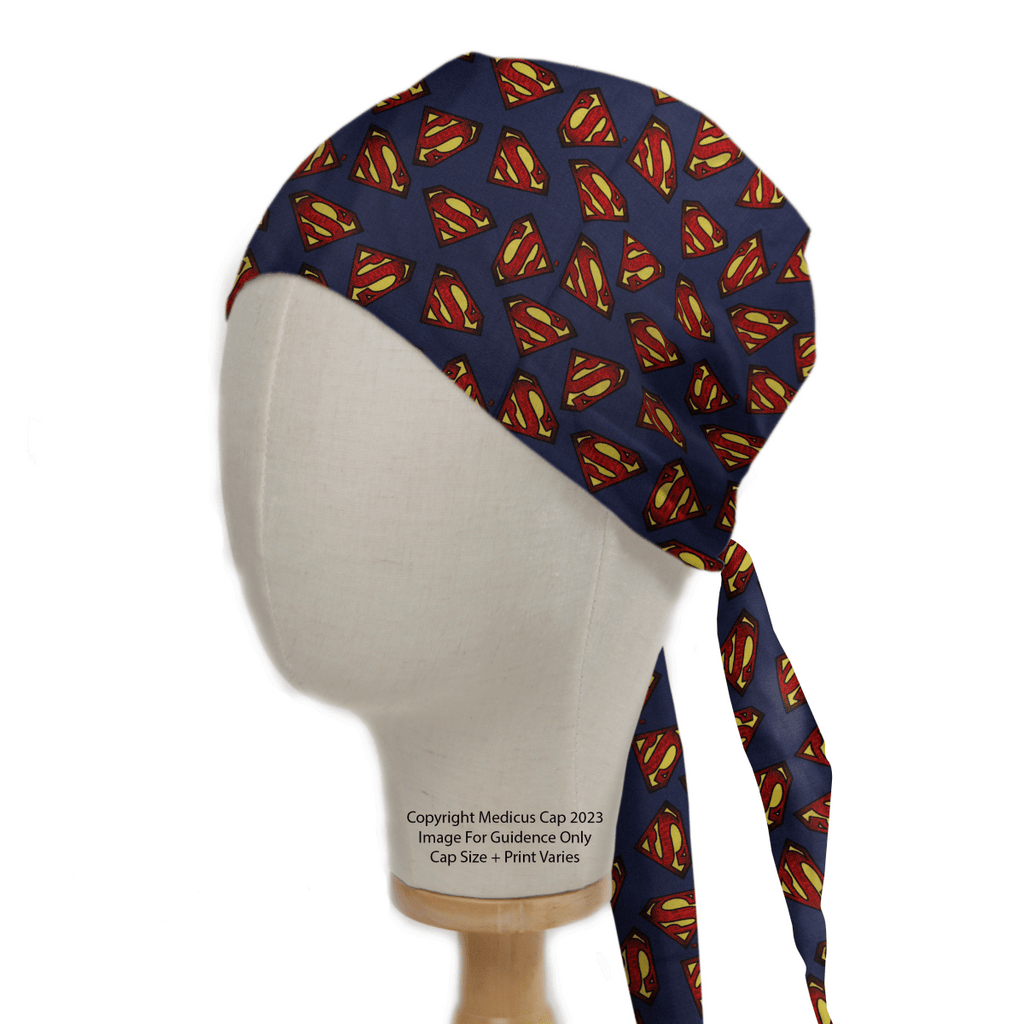 The mannequin head showcases a Medicus Scrub Caps Superman Logo On Navy Scrub Cap, featuring an eco-friendly design with a vibrant logo and a long tie-back strap.