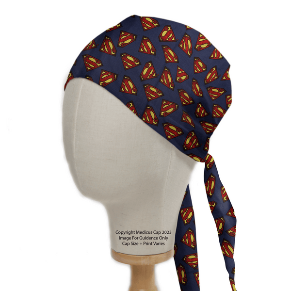 The mannequin head showcases a Medicus Scrub Caps Superman Logo On Navy Scrub Cap, featuring an eco-friendly design with a vibrant logo and a long tie-back strap.