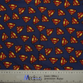 Medicus Scrub Caps eco-friendly Superman Logo On Navy Scrub Cap is designed with blue fabric showcasing red and yellow Superman logos, complete with a ruler at the bottom for measurements in centimeters and inches.