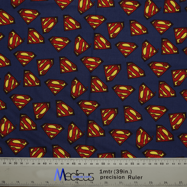 Medicus Scrub Caps eco-friendly Superman Logo On Navy Scrub Cap is designed with blue fabric showcasing red and yellow Superman logos, complete with a ruler at the bottom for measurements in centimeters and inches.